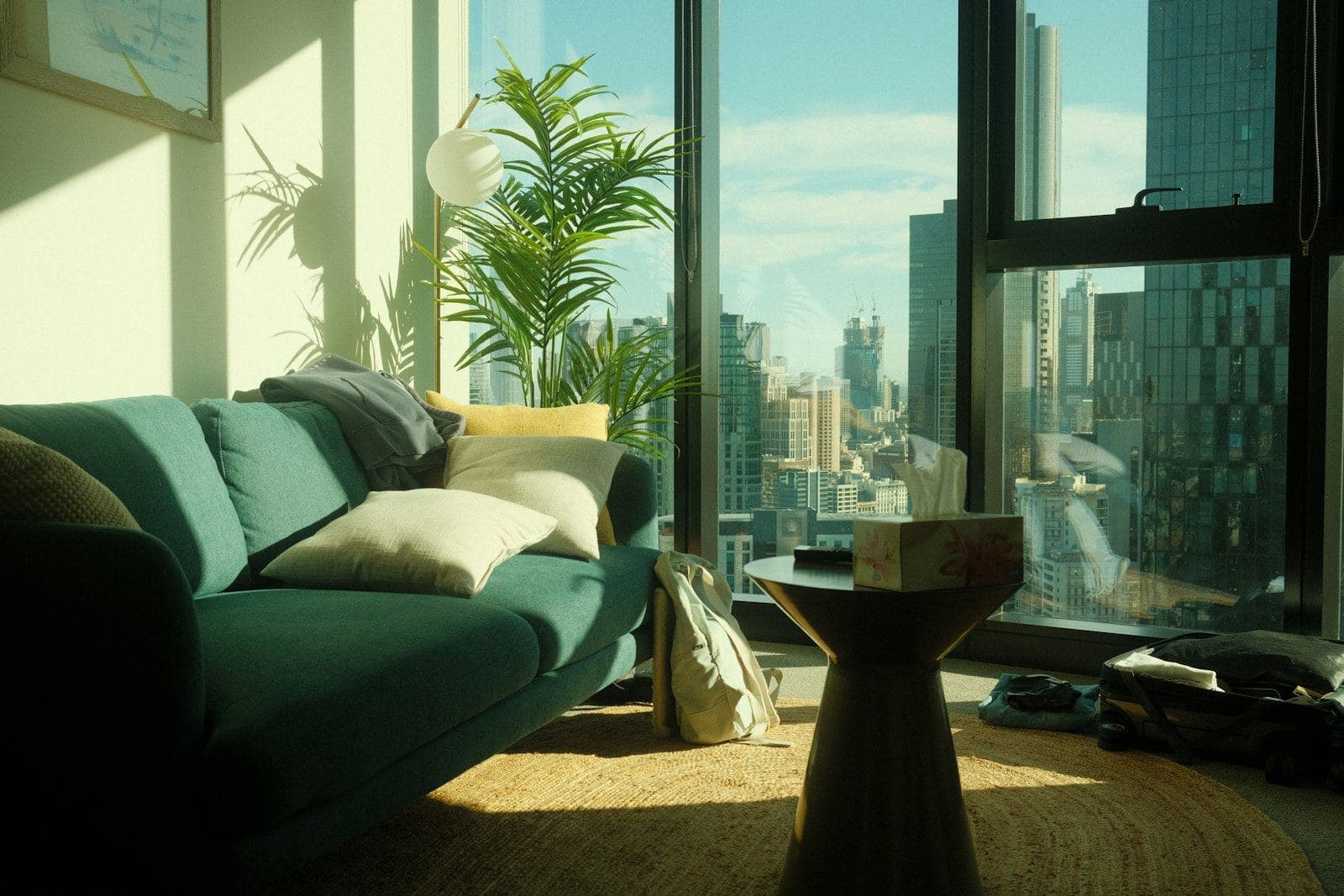A living room overlooking city towers